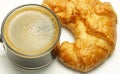 Breakfast, black coffee cup, a croissant is placed beside White background Royalty Free Stock Photo