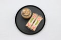 Breakfast in the black of round plate on the white floor. Strawberry and kiwi fruit with cream Sandwich, a glass of ice coffee Royalty Free Stock Photo