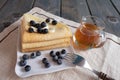 Breakfast, blueberries, freshly baked pancakes poured with honey on the plate