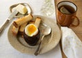 Breakfast with boiled egg, croutons, butter and tea