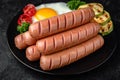 Breakfast of boiled sausages, fried eggs. Royalty Free Stock Photo