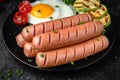 Breakfast of boiled sausages, fried eggs. Royalty Free Stock Photo