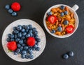 Breakfast bowl with granola made from oat flakes, dried fruits and nuts, and fresh blueberries and strawberries Royalty Free Stock Photo