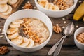 Breakfast bowl: oatmeal with banana, chia seeds, cinnamon, walnuts and honey Royalty Free Stock Photo