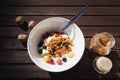 Breakfast in a bowl with walnuts, fresh fruit strawberries, gooseberries, currant, yoghurt