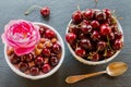 Breakfast bowl with yogurt, granola or muesli or oat flakes, fresh cherries and nuts. Black stone background, top view Royalty Free Stock Photo