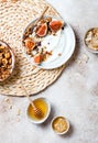 Breakfast bowls with granola, figs, yogurt, coconut chips and honey. Healthy vegan, vegetarian breakfast