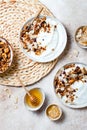 Breakfast bowls with granola, yogurt, coconut chips and honey. Healthy vegan, vegetarian breakfast