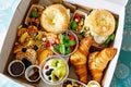 Breakfast in a box to go from closed restaurant due corona virus lockdown. Fresh bagels, croissants, berries, salad and