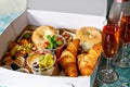 Breakfast in a box to go from closed restaurant due corona virus lockdown. Fresh bagels, croissants, berries, salad and