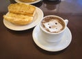 Breakfast at Brazil with french bread toasted with butter on the plate with capuccino on table Royalty Free Stock Photo