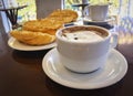 Breakfast at Brazil with french bread toasted with butter on the plate with capuccino on table Royalty Free Stock Photo