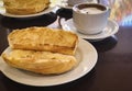 Breakfast at Brazil with french bread toasted with butter on the plate with capuccino on table Royalty Free Stock Photo