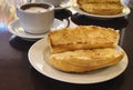 Breakfast at Brazil with french bread toasted with butter on the plate with capuccino on table Royalty Free Stock Photo