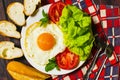 Breakfast with bread, fried eggs, milk and vegetables and fried tomato pieces on wood background. Royalty Free Stock Photo