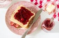 Breakfast of bread toasts with butter and strawberry-rhubarb jam, served with tea. Rustic style. Royalty Free Stock Photo