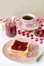 Breakfast of bread toasts with butter and strawberry-rhubarb jam, served with tea. Rustic style. Royalty Free Stock Photo