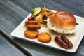 Breakfast brioche with fried egg, sausages, hash browns and salad