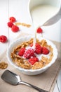 Breakfast with brown rice flakes, milk and fresh raspberries Royalty Free Stock Photo