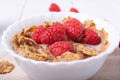Breakfast with brown rice flakes, milk and fresh raspberries Royalty Free Stock Photo