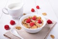 Breakfast with brown rice flakes, milk and fresh raspberries Royalty Free Stock Photo