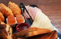 Breakfast brunch plate with cold cuts, croissant, cake and marmalade Royalty Free Stock Photo