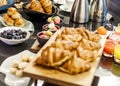 Breakfast buffet table with juice macaroons scones and berries and croissants Royalty Free Stock Photo