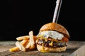 Breakfast burger with a fried egg on dark rustic surface, horizontal Royalty Free Stock Photo
