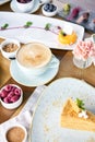 Cappuccino and lots of desserts on the table. Breakfast in the cafe, morning coffee. Eclair, mousse cake, chocolate Royalty Free Stock Photo