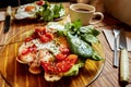 Breakfast at a cafe. Toast with egg, tomato, and spinach, with a cup of coffee Royalty Free Stock Photo