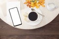 Breakfast in a cafe. Top view, flat lay. Mockup of a modern smartphone with a cup of coffee with cookies