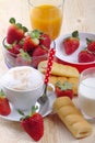 Breakfast with cappuccino, afternoon snack, strawberries and fruit juice