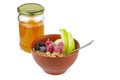 Breakfast: ceramic bowl with oat flats, frozen berries, apple and glass jar with honey Royalty Free Stock Photo