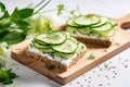 Breakfast, cereal bread sandwiches, cream cheese, sliced cucumber, with micro greenery on a light table