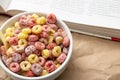 Breakfast cereal concept, Colorful ring cereals for breakfast meal and reading a book