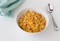 Breakfast cereal of cornflakes in bowl on white table Royalty Free Stock Photo