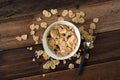 Breakfast cereal cornflakes in a bowl on a wooden table background Royalty Free Stock Photo