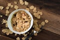 Breakfast cereal cornflakes in a bowl on a wooden table background Royalty Free Stock Photo