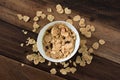 Breakfast cereal cornflakes in a bowl on a wooden table background Royalty Free Stock Photo