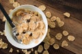 Breakfast cereal cornflakes with milk in a bowl on a wooden table background Royalty Free Stock Photo