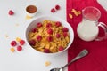 Breakfast cereal of cornflakes, raspberries, honey and milk on w Royalty Free Stock Photo