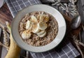 Breakfast cereal porridge with oats, amaranth, quinoa and bananas, nuts and maple syrup