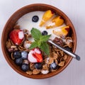 Breakfast of cereals and fruits with yoghurt in Clay bowls on a white tablecloth  top view Royalty Free Stock Photo