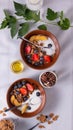 Breakfast of cereals and fruits with yoghurt in Clay bowls on a white tablecloth  top view Royalty Free Stock Photo