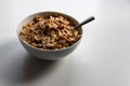 Breakfast cereals with healthy cornflakes and delicious walnuts and honey in a bowl are the perfect start in the day