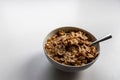 Breakfast cereals with healthy cornflakes and delicious walnuts and honey in a bowl are the perfect start in the day