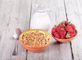 Breakfast with cereals, milk and strawberries