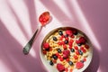 Breakfast cereals rings in a white bowl. Oatmeal, corn flakes on a pink background. Breakfast or brunch buffet in a hotel or