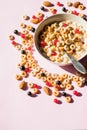 Breakfast cereals rings in a white bowl. Oatmeal, corn flakes on a pink background. Breakfast or brunch buffet in a hotel or