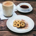 Breakfast chocolate biscuits and coffee with milk-